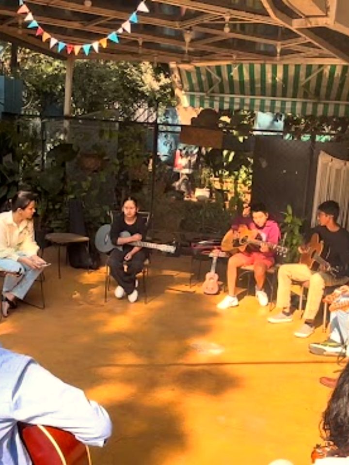 A group of young musicians playing together outdoors at a Song Pod